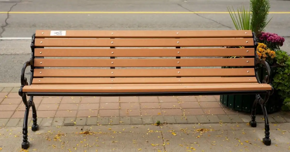 Custom metal and wooden bench beside urban street